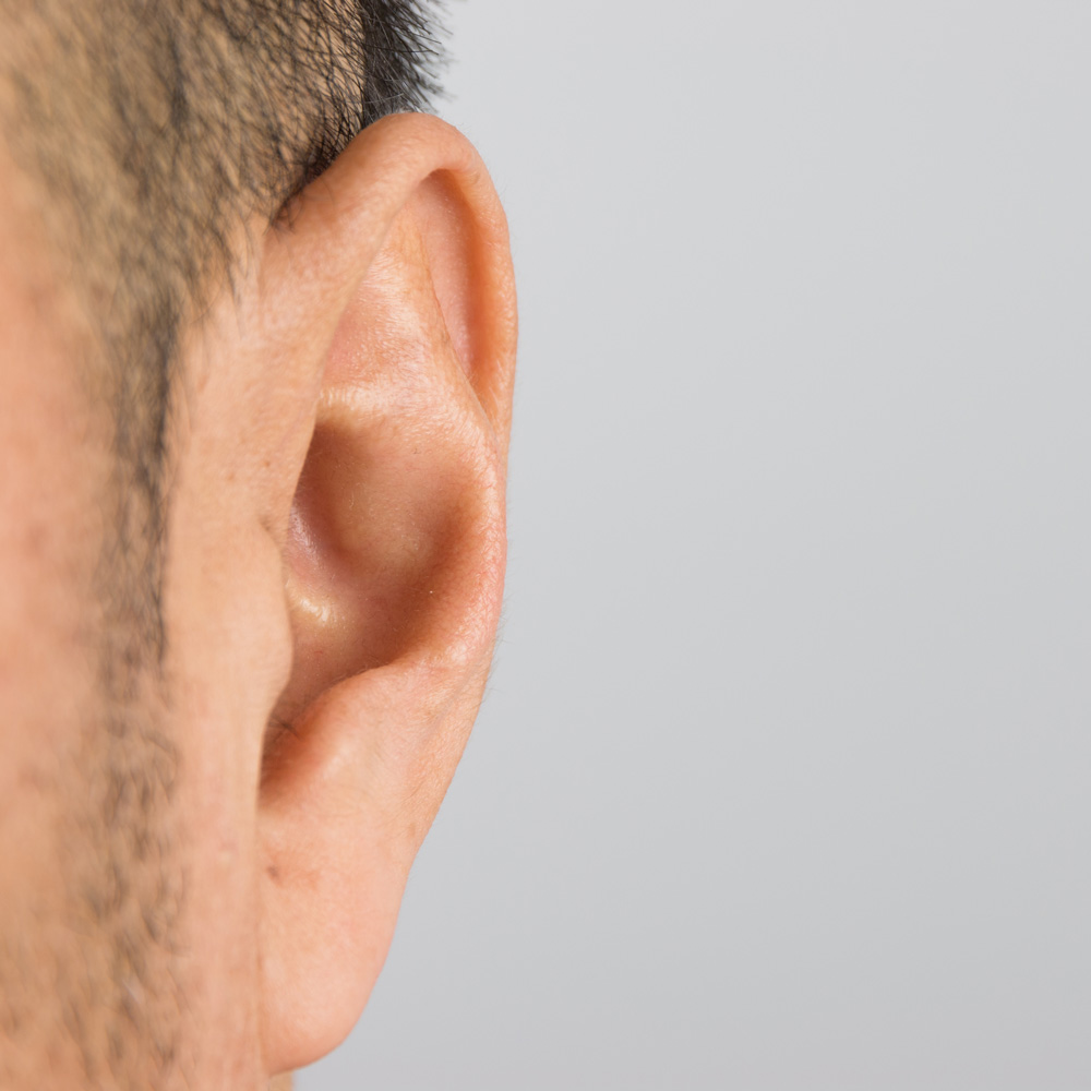 close up image of a white mans ear